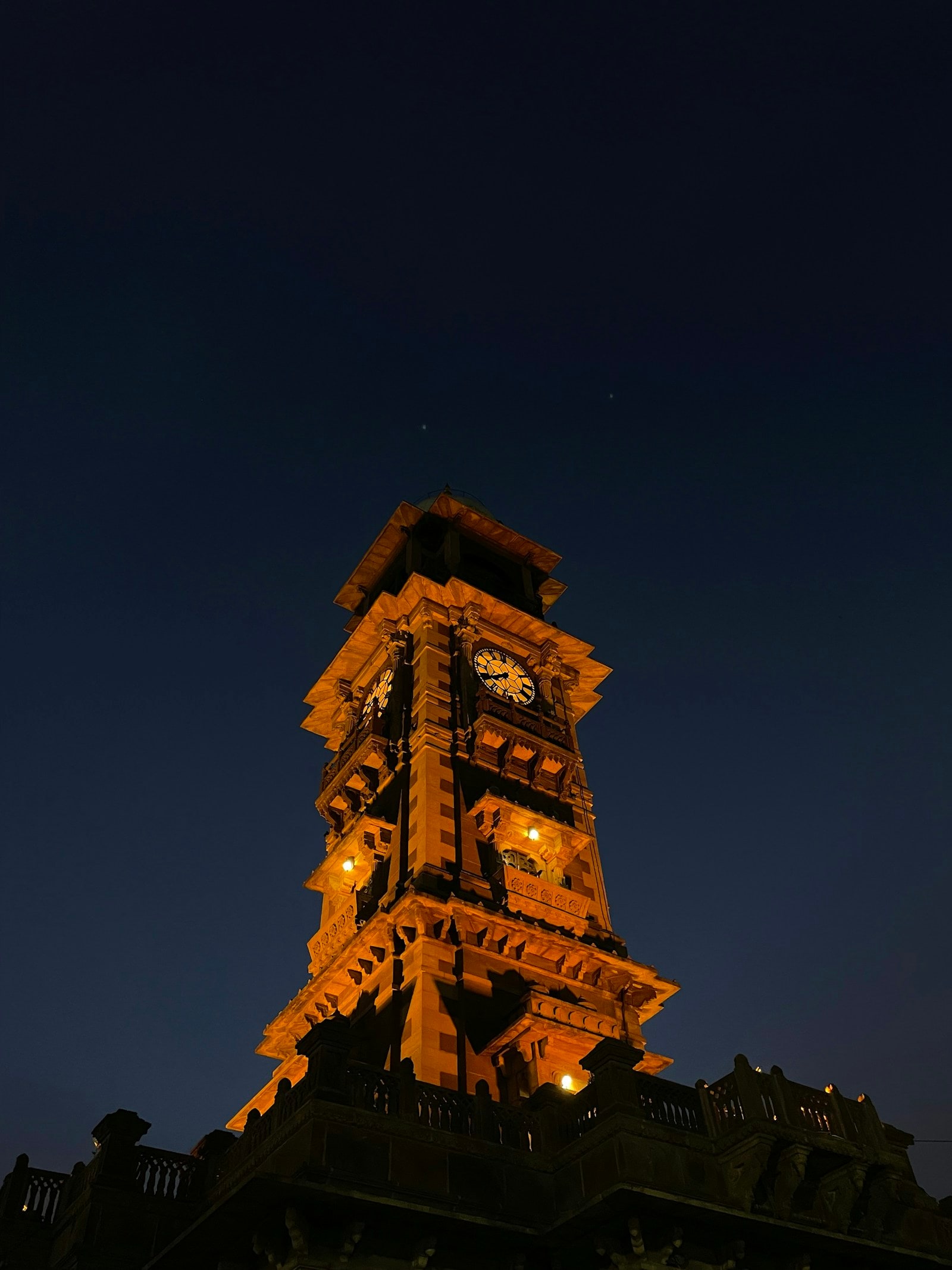 Jodhpur's Ghanta Ghar Clock Tower illuminated against a deep blue night sky