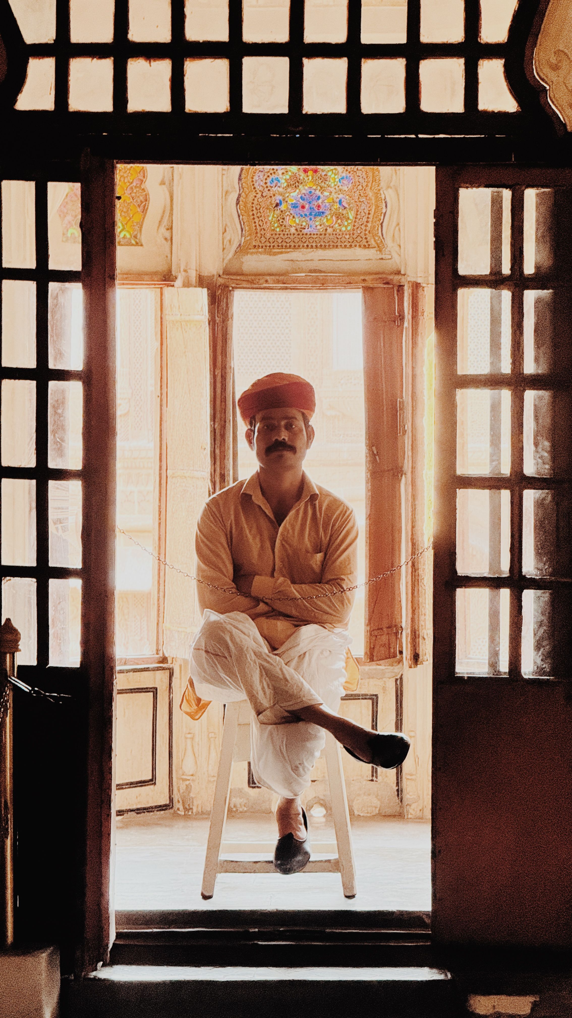A Rajasthani man seated inside a historic Jodhpur building